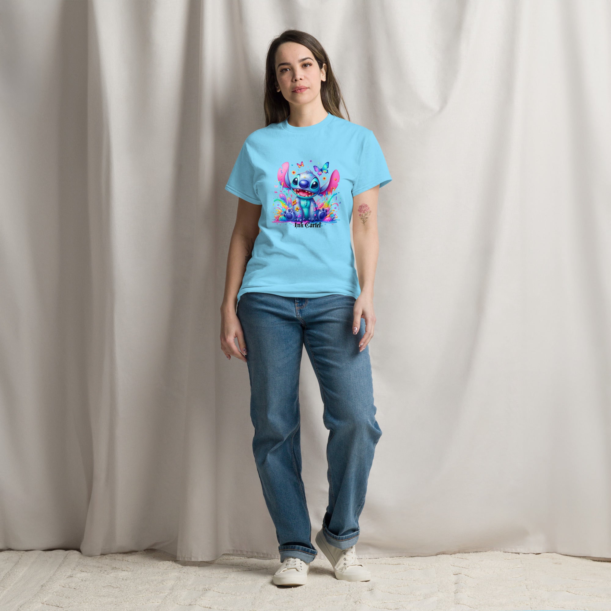  Ink Cartel exclusive streetwear design showing a cartoon-style blue character splashing through dripping black and colorful ink, creating a bold graffiti-inspired visual on a premium t-shirt