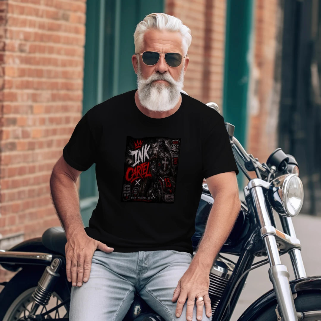 Man sitting on a motorcycle wearing a black t-shirt with graphic design, sunglasses, and gray hair.
